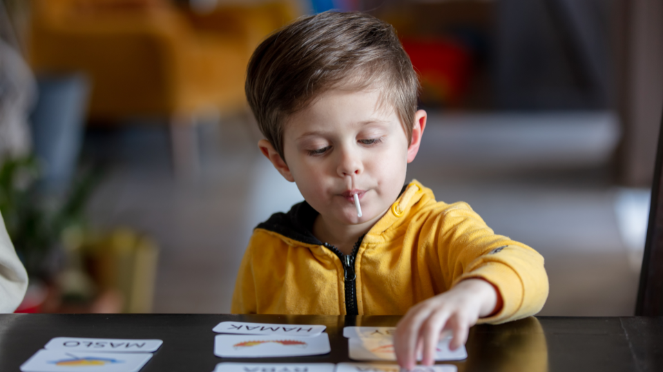 Little Boy Learns Words from Cards under the ABA Therapy Program